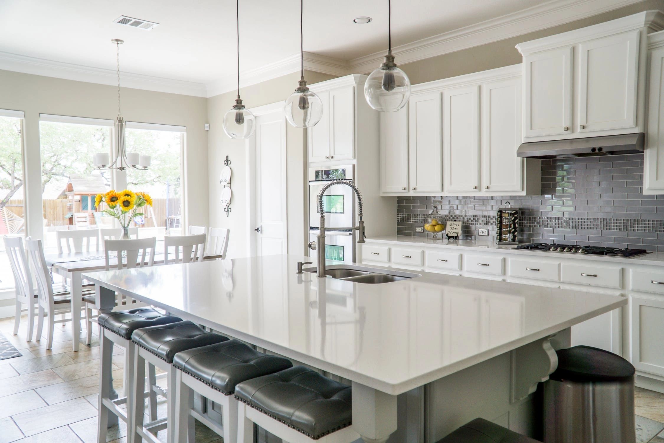 Bright kitchen with white cabinetry and a generous island, featured on Delta’s existing website