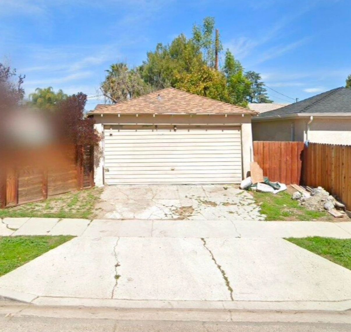 Before construction: detached garage with a concrete driveway